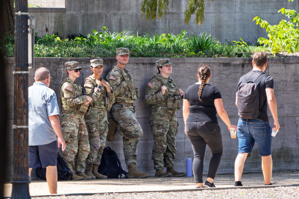National Guard soldiers stand outside the Smithsonian Air and Space Museum on the National Mall in Washington, as part of President Donald Trump's order to use federal law enforcement to expel homeless people and rid the nation's capital of violent crime, Monday, Aug. 25, 2025. (AP Photo/J. Scott Applewhite)