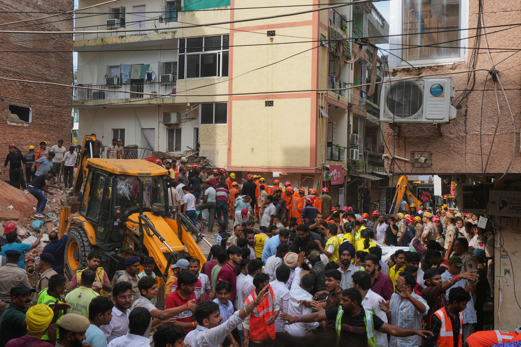 Rescue workers search for survivors under the rubble of a collapsed building in New Delhi, India, Sunday, Sept. 6, 2026. (AP Photo/Rajesh Kumar Singh)