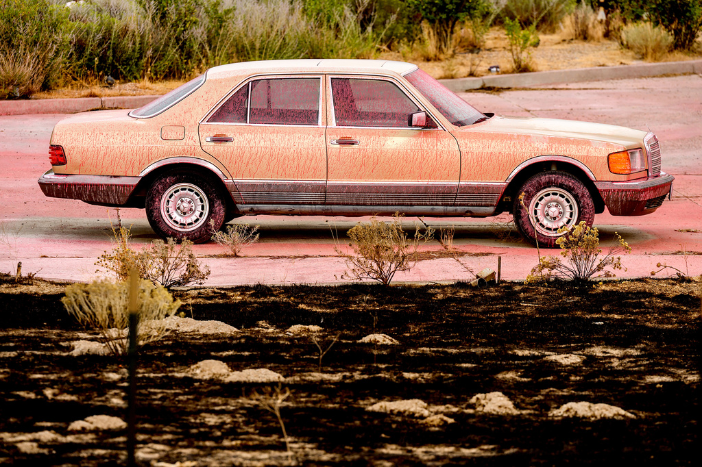 Fire retardant coats a vehicle following the Bug Fire near Reno, Nev., Thursday, Aug. 13, 2026. (AP Photo/Noah Berger)
