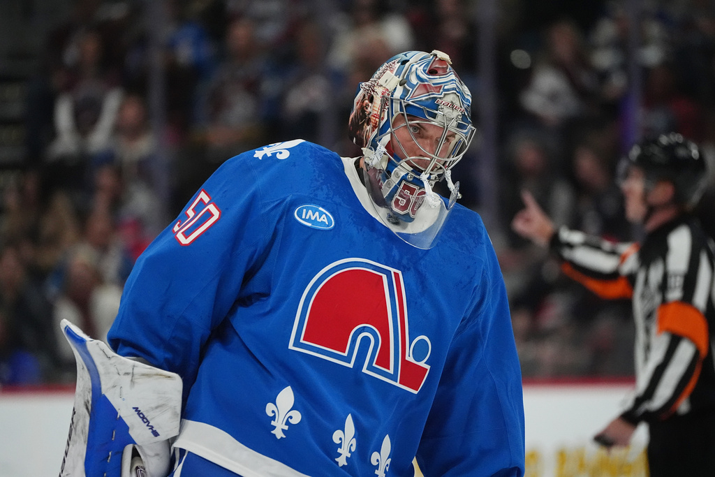 Colorado Avalanche goaltender Trent Miner returns to the net after a time out against the Carolina Hurricanes in the second period of an NHL hockey game Thursday, Oct. 23, 2025, in Denver. (AP Photo/David Zalubowski)