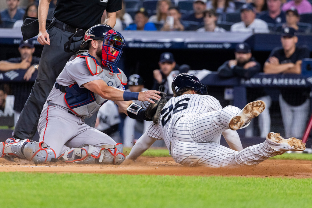 Boston Red Sox catcher Connor Wong, left, tags out New York Yankees' Luis García Jr. (26) after Spencer Jones hit into a fielder's choice in the second inning during the second baseball game of a doubleheader, Saturday, Aug. 29, 2026, in New York. (AP Photo/Corey Sipkin)