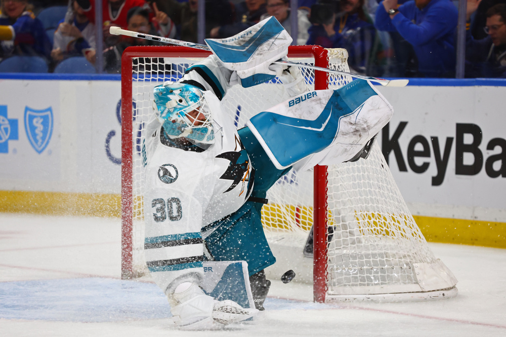 San Jose Sharks goaltender Yaroslav Askarov (30) slides across the crease as the puck goes in on a shot by Buffalo Sabres right wing Jack Quinn during the first period of an NHL hockey game Tuesday, March 10, 2026, in Buffalo, N.Y. (AP Photo/Jeffrey T. Barnes)