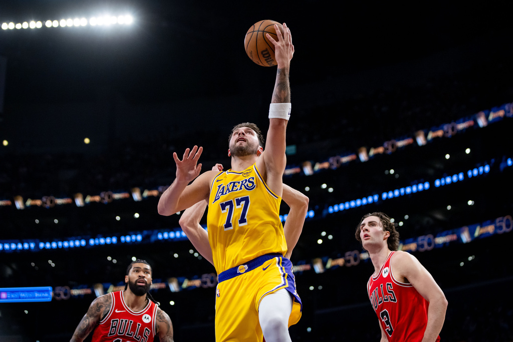 Los Angeles Lakers guard Luka Doncic (77) goes to the basket against the Chicago Bulls during the first half of an NBA basketball game against the Chicago Bulls, Thursday, March 12, 2026, in Los Angeles. (AP Photo/Ethan Swope)