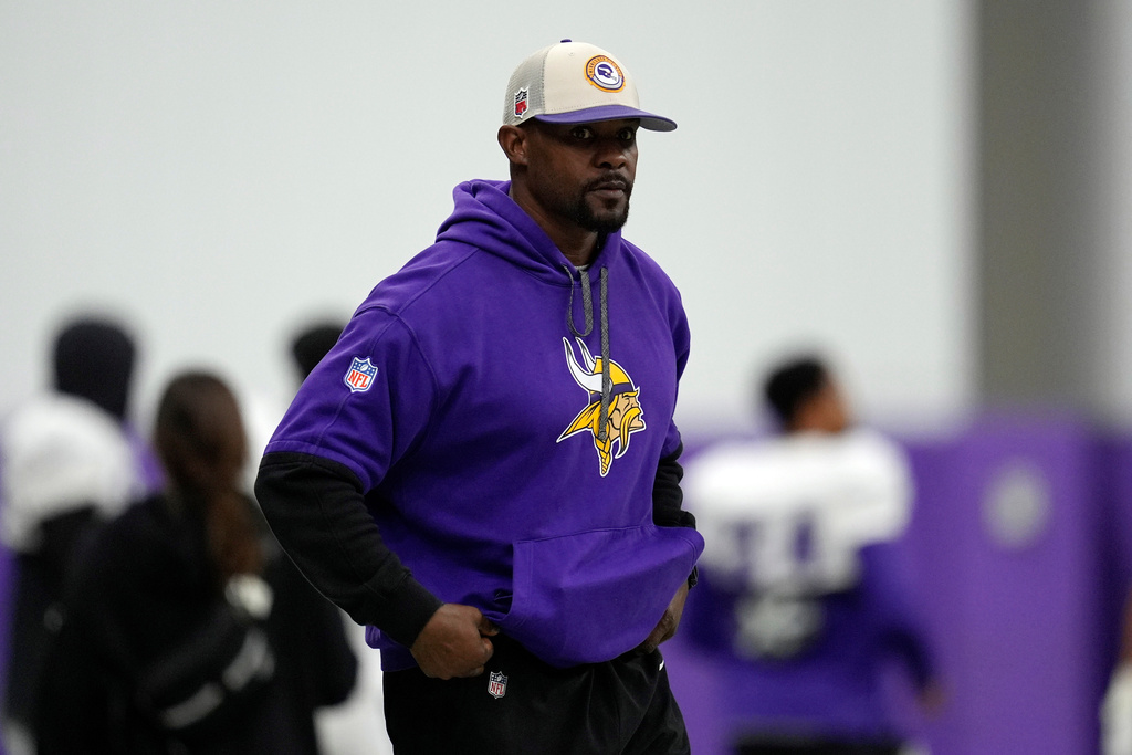 FILE - Minnesota Vikings defensive coordinator Brian Flores stands on the field during an NFL football workout in Eagan, Minn., Oct. 30, 2024. (AP Photo/Abbie Parr, File)