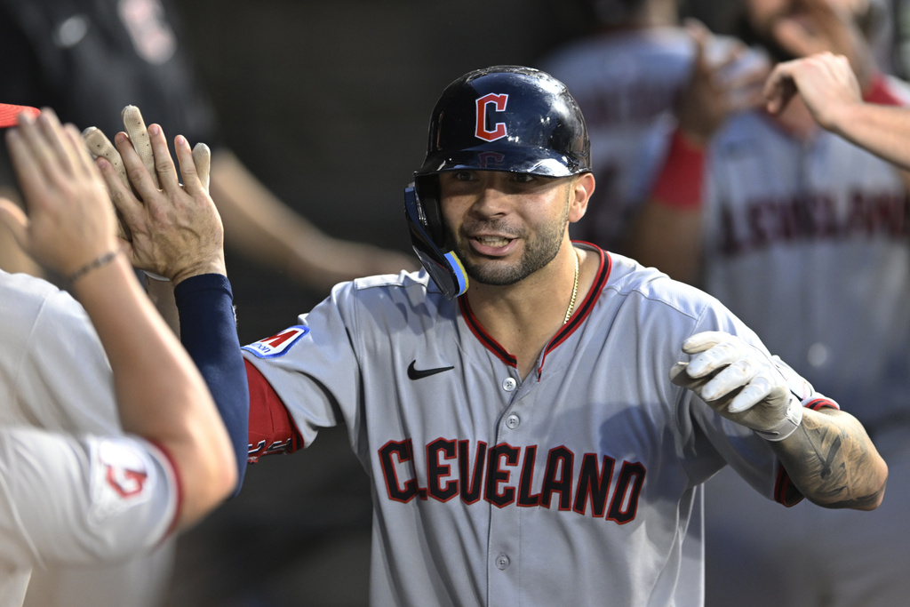 Cleveland Guardians' C.J. Kayfus celebrates with teammates in the dugout after hitting a solo home run during the sixth inning of a baseball game against the Chicago White Sox, Saturday, Aug. 9, 2025, in Chicago. (AP Photo/Paul Beaty)