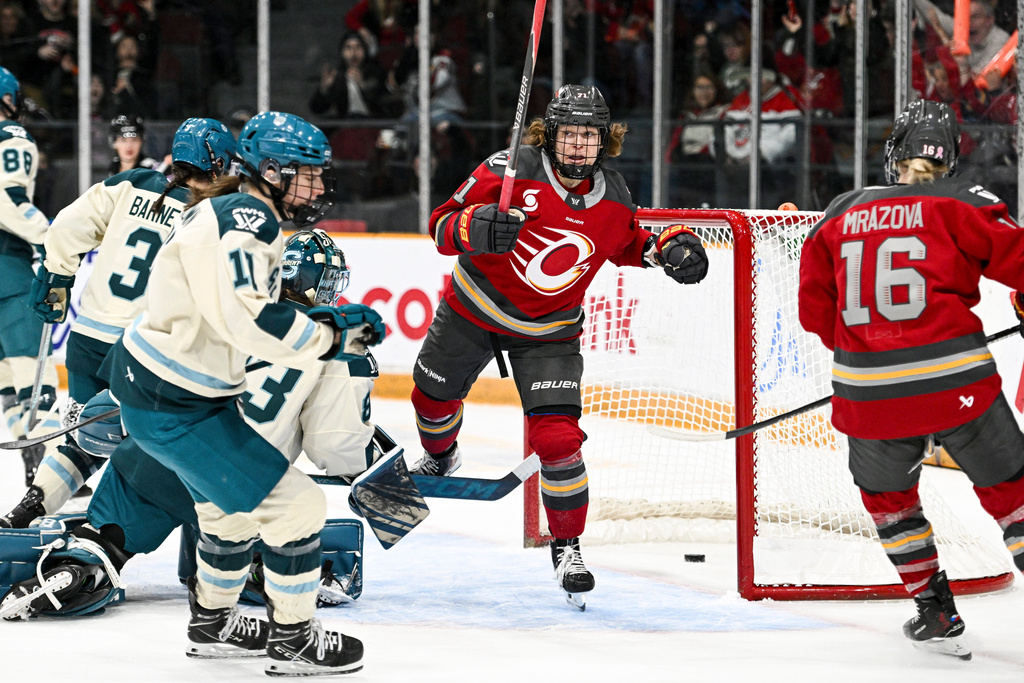 Ottawa Charge's Fanuza Kadirova (centre) spins around as she celebrates her goal on Seattle Torrent goaltender Hannah Murphy (83) during the first period of an PWHL hockey game in Ottawa, Wednesday, March 4, 2026. (Spencer Colby/The Canadian Press via AP)