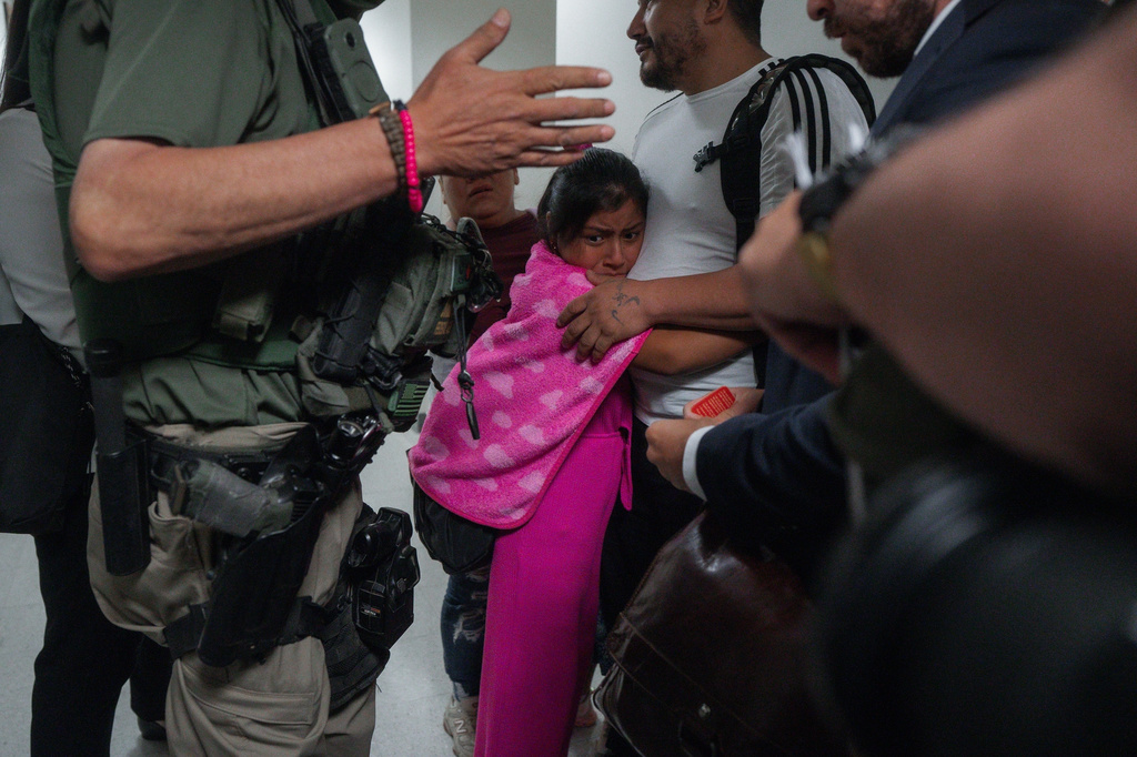 FILE - An asylum seeker from Ecuador hugs her father as he is detained by federal agents July 31, 2025 (AP Photo/Olga Fedorova, File)