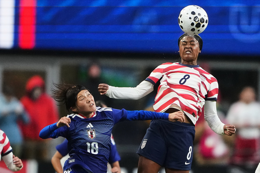 United States midfielder Jaedyn Shaw (8) goes up for the ball against Japan midfielder Honoka Hayashi (18) during the first half of an international friendly soccer match Tuesday, April 14, 2026, in Seattle. (AP Photo/Lindsey Wasson)
