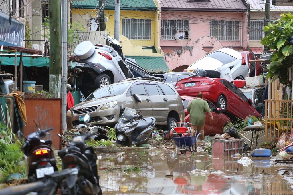 Vehicles lie piled on after flooding caused by Typhoon Kalmaegi in Cebu city, central Philippines, Tuesday, Nov. 4, 2025. (AP Photo/Jacqueline Hernandez)