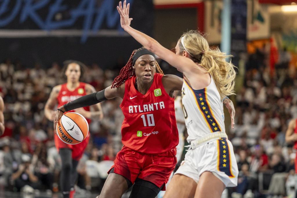 Atlanta Dream guard Rhyne Howard (10) drives the ball during the first half of Game 1 against the Indiana Fever in the first round of the WNBA basketball playoffs Sunday, Sept. 14, 2025, in Atlanta. (AP Photo/Erik Rank)