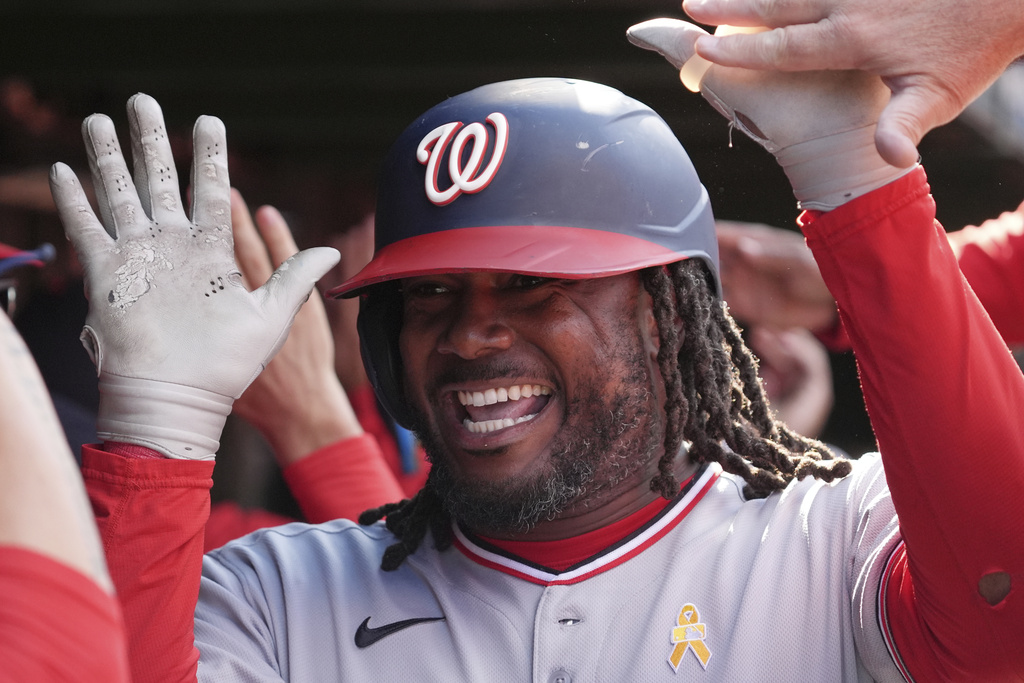 Washington Nationals' Josh Bell celebrates with teammates after hitting a three-run home run during the ninth inning of a baseball game against the Chicago Cubs in Chicago, Sunday, Sept. 7, 2025. (AP Photo/Nam Y. Huh)
