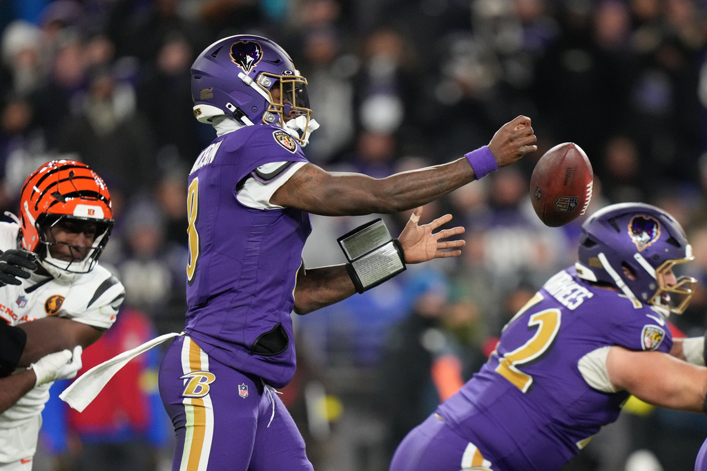 Baltimore Ravens quarterback Lamar Jackson (8) fumbles the ball during the first half of an NFL football game against the Cincinnati Bengals, Thursday, Nov. 27, 2025, in Baltimore. (AP Photo/Stephanie Scarbrough)