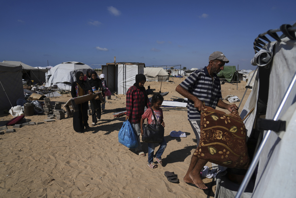 The Abu Jarad family moves their belongings into a newly built tent in Khan Younis, Gaza Strip, after being displaced from Gaza City, Sept. 11, 2025. (AP Photo/Abdel Kareem Hana)