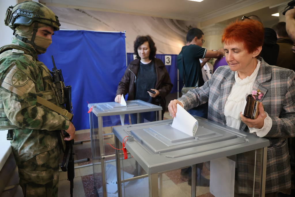 Voters cast ballots at a polling station during Russia's parliamentary election, in the Russian-controlled part of the Donetsk region, Ukraine, Friday, Sept. 18, 2026. (AP Photo)