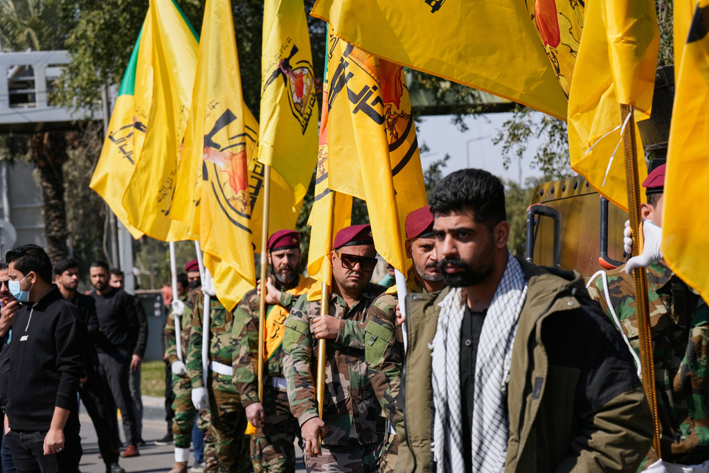 Members of an Iraqi Shiite militant group attend a funeral of a fighter of the Kataib Hezbollah, who was killed in a U.S. airstrike, in Baghdad, Iraq, Monday, March 2, 2026. (AP Photo/Hadi Mizban)