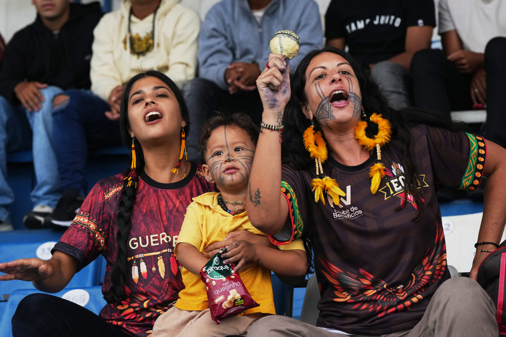 Fans of Originarios, a new soccer team in Rio's fifth division made up exclusively of Indigenous players, cheer during a match against Barcelona in Rio de Janeiro, Sunday, May 3, 2026. (AP Photo/Silvia Izquierdo)