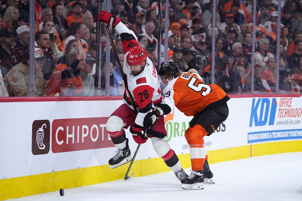 Carolina Hurricanes' William Carrier, left, tries to get past Philadelphia Flyers' Oliver Bonk, right, during the third period of Game 4 in a second-round NHL hockey Stanley Cup playoff series Saturday, May 9, 2026, in Philadelphia. (AP Photo/Matt Slocum)