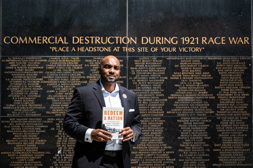 Damario Solomon-Simmons poses for a portrait at the memorial for the 1921 Tulsa Race Massacre on Saturday, May 2, 2026, in Tulsa, Okla. Solomon-Simmons is the author of a new book about reparations over the Tulsa Race Massacre (AP Photo/Milo Gladstein)