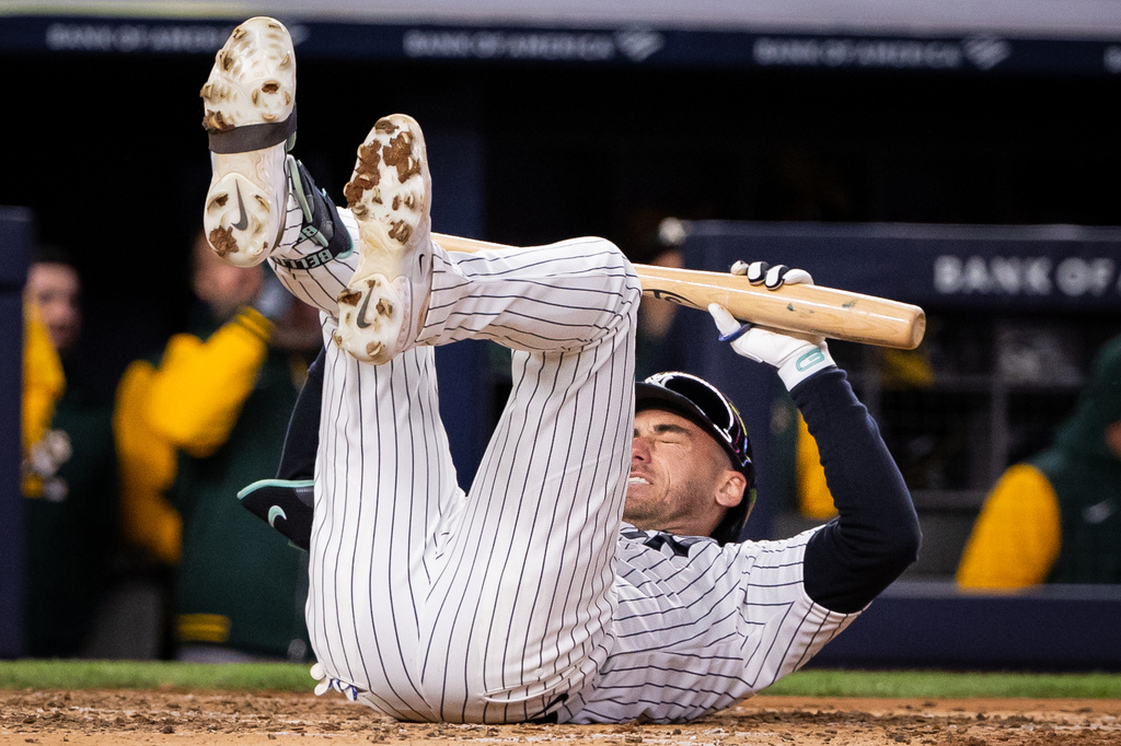 New York Yankees left fielder Cody Bellinger (35) drops to the ground after striking during the fifth inning of a baseball game against the Athletics, Tuesday, April 7, 2026, in New York. (AP Photo/Angelina Katsanis)