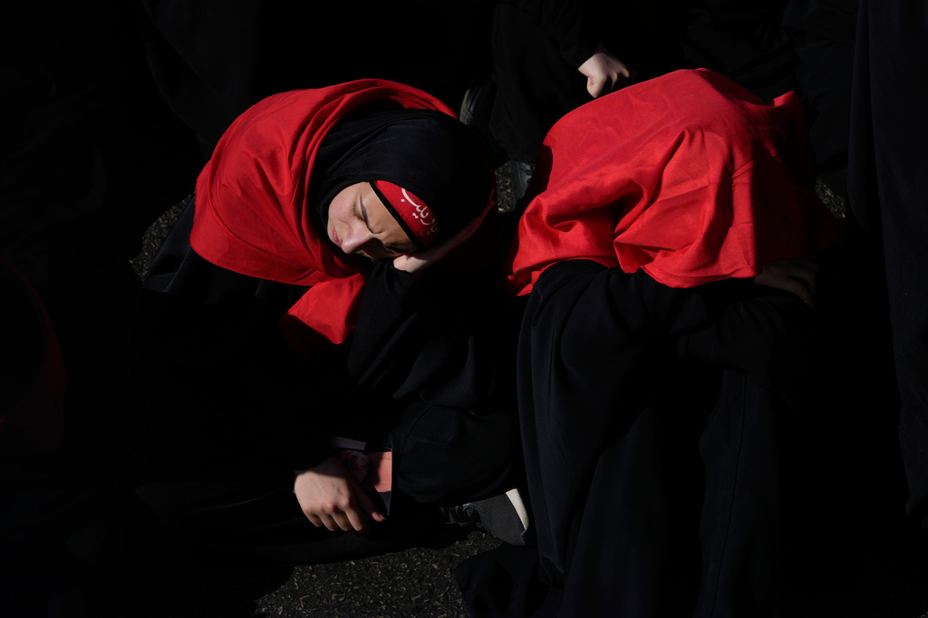 A Hezbollah supporter mourns as she listens to the death story of Imam Hussein during the holy day of Ashoura that commemorates the 7th century martyrdom of the Prophet Muhammad's grandson Hussein, in Dahiyeh, Beirut's southern suburbs, Lebanon, Friday, June 26, 2026. (AP Photo/Hussein Malla) (AP Photo/Hussein Malla)