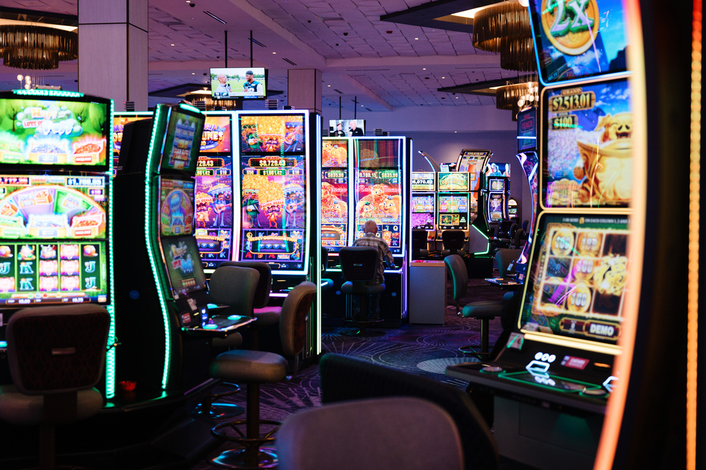 A person plays a slot machine at Harrah's Casino, owned by the Iowa Tribe of Oklahoma, in Chandler, Okla., Wednesday, Aug. 5, 2026. (AP Photo/Brittany Bendabout)