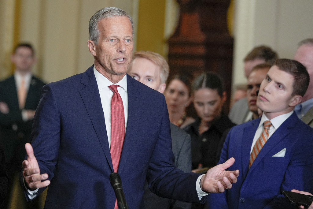 Senate Majority Leader John Thune, R-S.D., left, speaks during a news conference after a policy luncheon at the Capitol, Tuesday, Sept. 30, 2025, in Washington. (AP Photo/Mariam Zuhaib)
