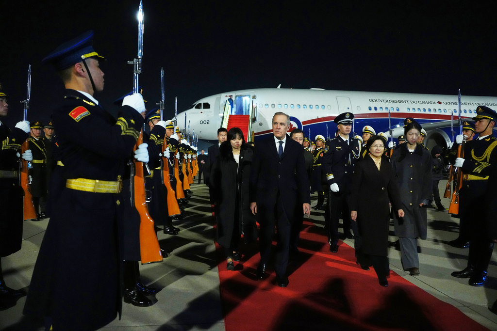 Canada's Prime Minister Mark Carney is given a welcome ceremony after deplaning in Beijing, China, Wednesday, Jan. 14, 2026. (The Canadian Press/Sean Kilpatrick, via AP)