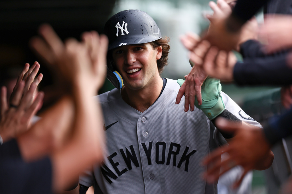 New York Yankees' Spencer Jones celebrates with teammates in the dugout after hitting a home run during the fifth inning of a baseball game against the Chicago Cubs in Chicago, Friday, July 31, 2026. (AP Photo/Jessie Alcheh)