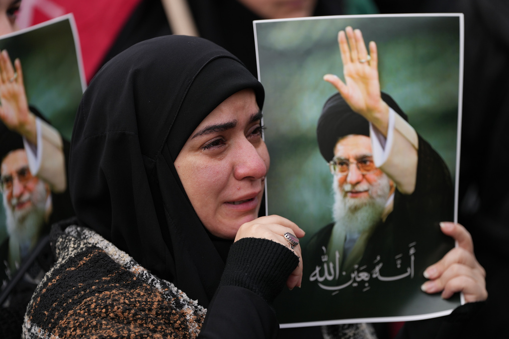A woman cries as she mourns the death of Iranian Supreme Leader Ayatollah Ali Khamenei, during a gathering in the southern Suburb of Beirut, Lebanon, Sunday, March 1, 2026. (AP Photo/Hassan Ammar)