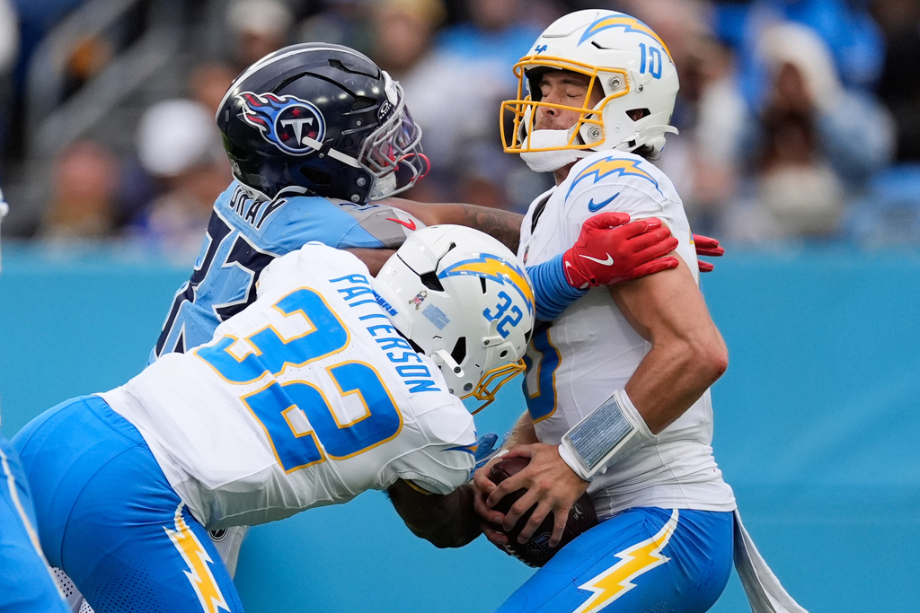 Los Angeles Chargers quarterback Justin Herbert (10) is sacked by Titans linebacker Cedric Gray (33) of an NFL football game Sunday, Nov. 2, 2025, in Nashville, Tenn. (AP Photo/George Walker IV)