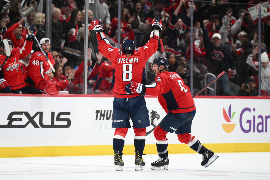 Washington Capitals left wing Alex Ovechkin (8) celebrates his goal with defenseman Jakob Chychrun (6) during the second period of an NHL hockey game against the Winnipeg Jets, Wednesday, Nov. 26, 2025, in Washington. (AP Photo/Nick Wass)