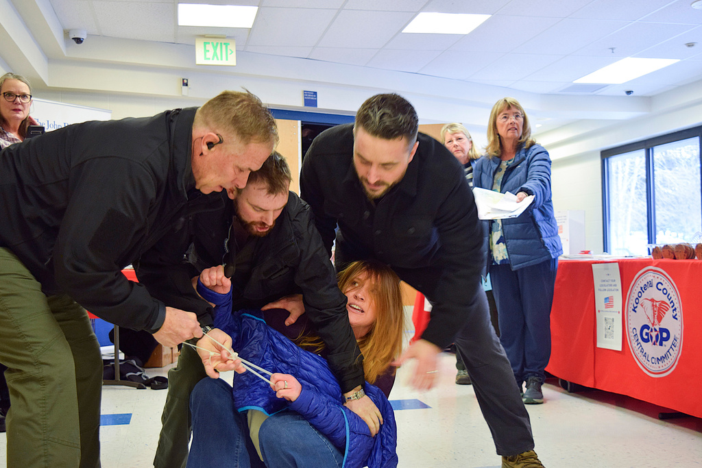 FILE - Employees of a security firm, LEAR Asset Management, drag Post Falls resident Teresa Borrenpohl out of a town hall meeting on Saturday, Feb. 22, 2025, in Post Falls, Idaho. (Hailey Hill/Coeur D'Alene Press via AP, File)