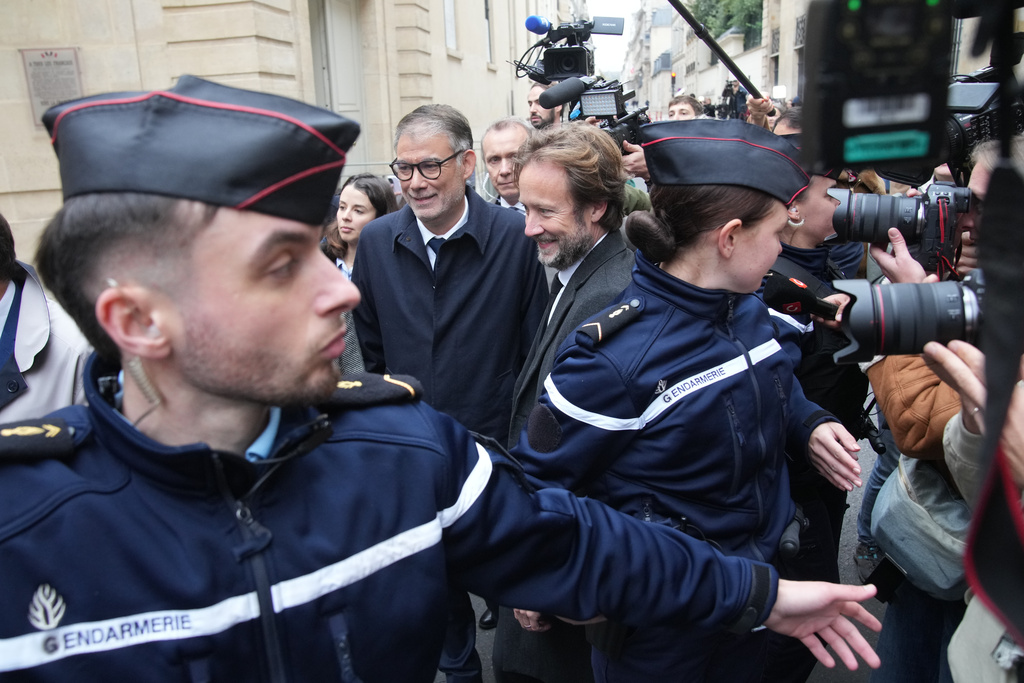 French socialist party secretary general Olivier Faure, center left, and Boris Vallaud, center right, president of the socialist parliament members at the National Assembly, arrive for a meeting with outgoing Prime Minister Sebastien Lecornu, Wednesday, Oct. 8, 2025 in Paris. (AP Photo/Christophe Ena)