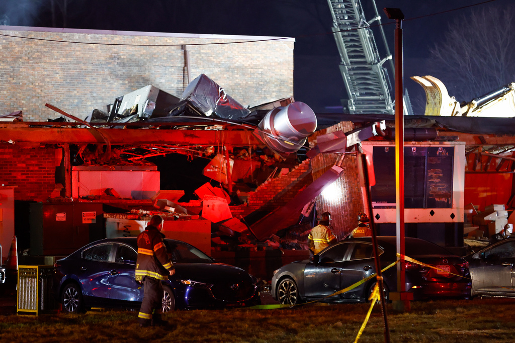 Emergency personnel work at the scene of an explosion and fire at Bristol Health & Rehab Center, Tuesday, Dec. 23, 2025, in Bristol, Pa. (Monica Herndon/The Philadelphia Inquirer)