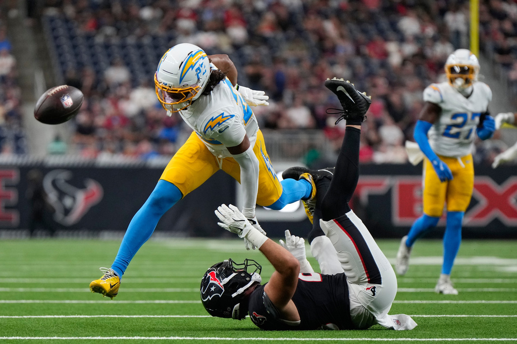 Los Angeles Chargers safety Genesis Smith (22) is called for interference as he breaks up a pass intended for Houston Texans tight end Marlin Klein (83) during the first half of an NFL preseason football game Thursday, Aug. 13, 2026, in Houston. (AP Photo/Ashley Landis)
