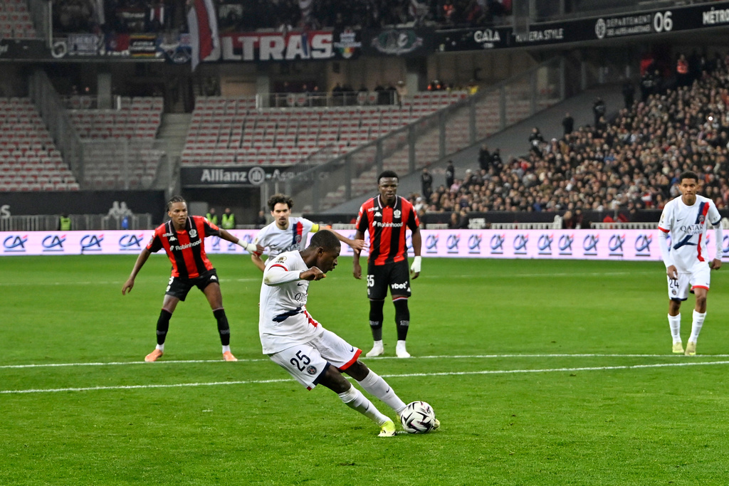 PSG's Nuno Mendes scores the opening goal from the penalty spot during the French League One soccer match between Nice and Paris Saint-Germain in Nice, France, Saturday, March 21, 2026. (AP Photo/Philippe Magoni)