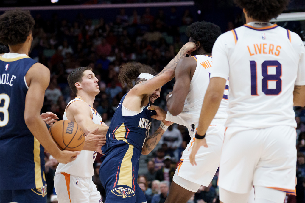 New Orleans Pelicans guard Jose Alvarado, left, and Phoenix Suns center Mark Williams (15) get into a scrum during the third quarter before both were ejected during an NBA basketball game in New Orleans, Saturday, Dec. 27, 2025. (AP Photo/Matthew Hinton)