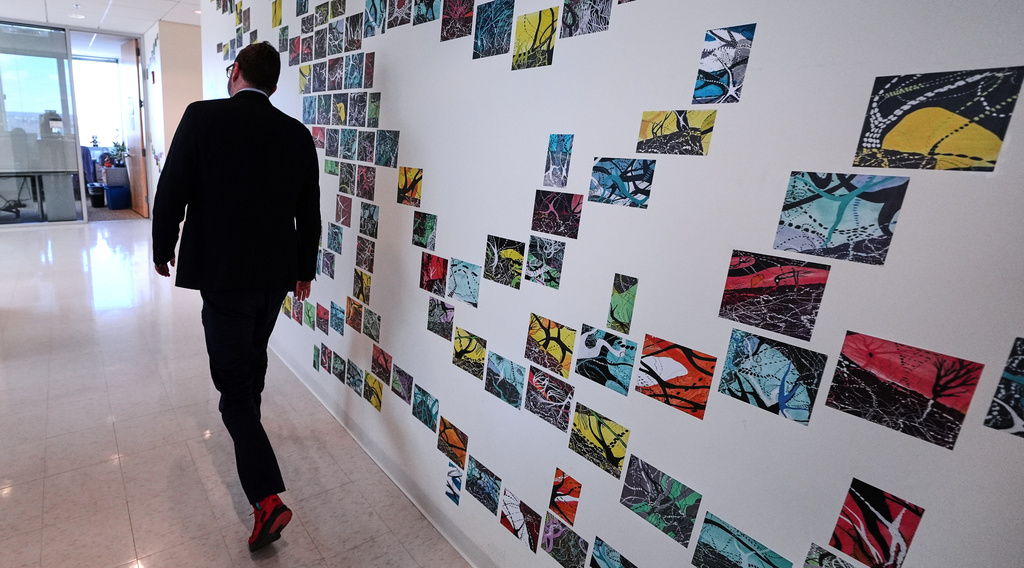 Benjamin Neale, co-director of the Stanley Center for Psychiatric Research, walks through the laboratory floor at the Broad Institute, Tuesday, March 17, 2026, in Cambridge, Mass. (AP Photo/Charles Krupa)