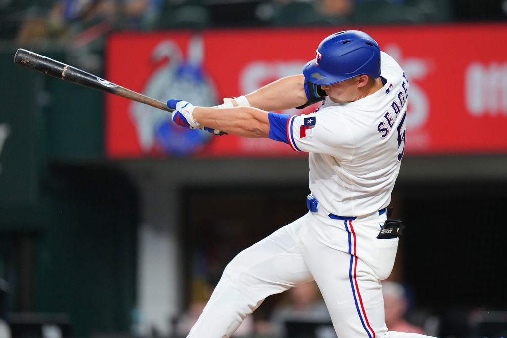 Texas Rangers' Corey Seager follows through while collecting a double against the Athletics during the third inning of a baseball game Tuesday, Sept. 1, 2026, in Arlington, Texas. (AP Photo/Julio Cortez)