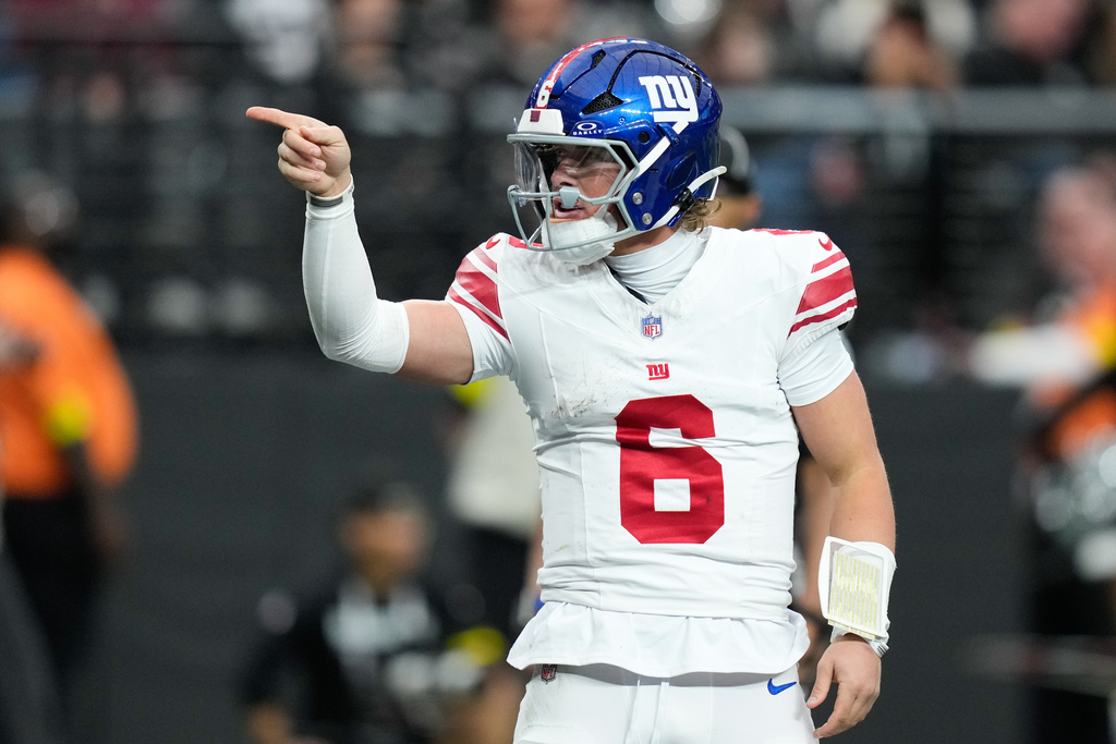New York Giants quarterback Jaxson Dart celebrates his touchdown during the first half of an NFL football game against the Las Vegas Raiders Sunday, Dec. 28, 2025, in Las Vegas. (AP Photo/John Locher)