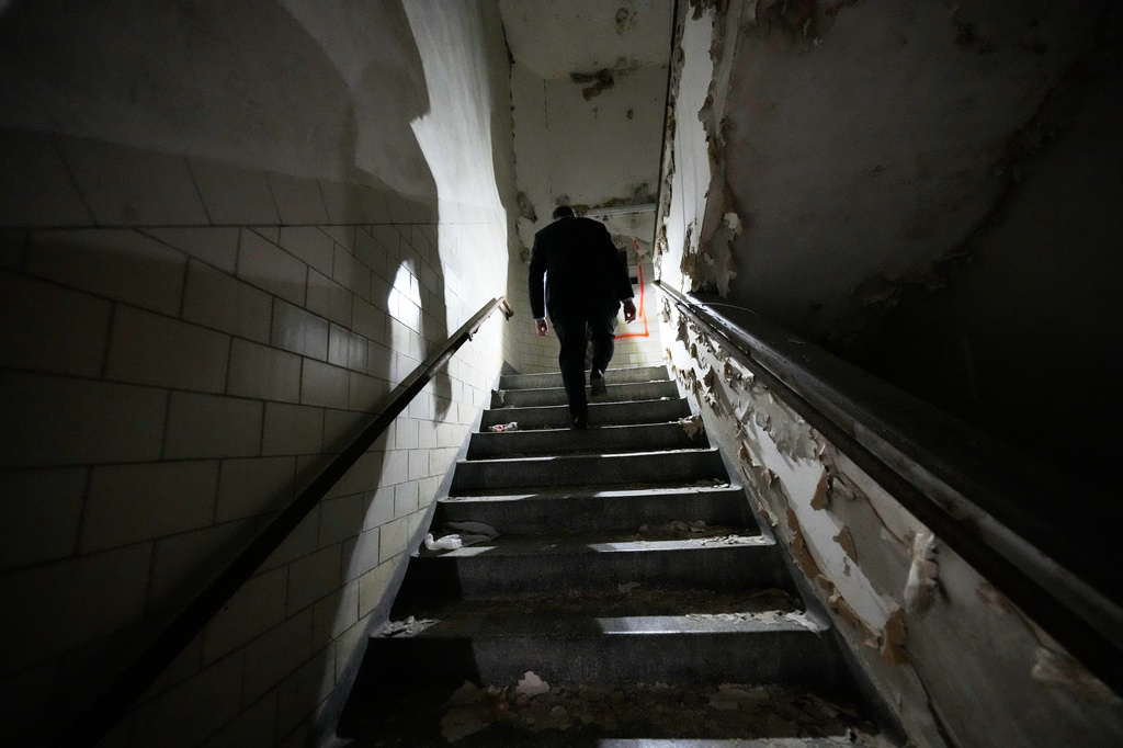 Tulane University president Michael A. Fitts walks up a stairwell inside the old Charity Hospital building Wednesday, Aug. 19, 2026, in New Orleans. (AP Photo/Gerald Herbert)