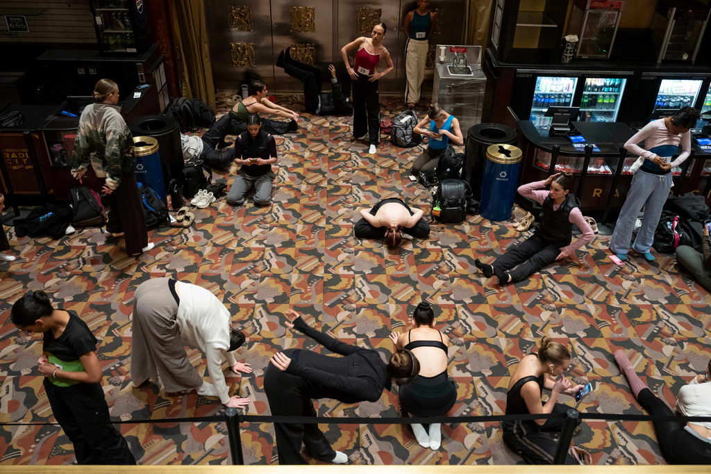 Dancers warm up and stretch before an audition for the Radio City Rockettes at Radio City Music Hall in New York, on Wednesday, April 22, 2026. (AP Photo/Yuki Iwamura)