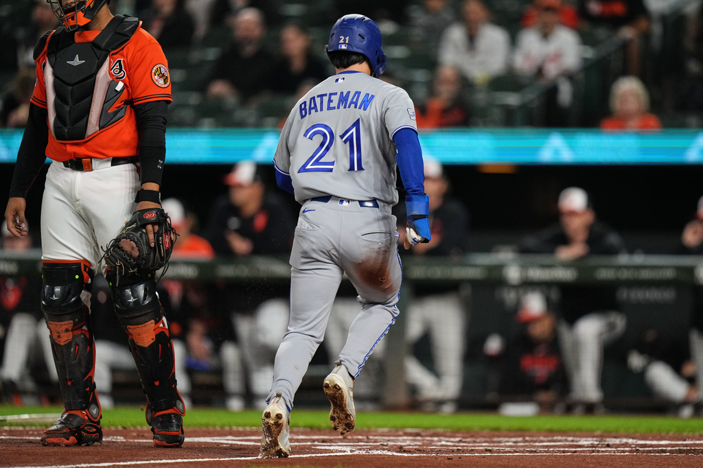 Toronto Blue Jays' Brett Bateman (21) scores on an RBI single hit by Nathan Lukes during the first inning of a baseball game against the Baltimore Orioles, Monday, Sept. 21, 2026, in Baltimore. (AP Photo/Stephanie Scarbrough)