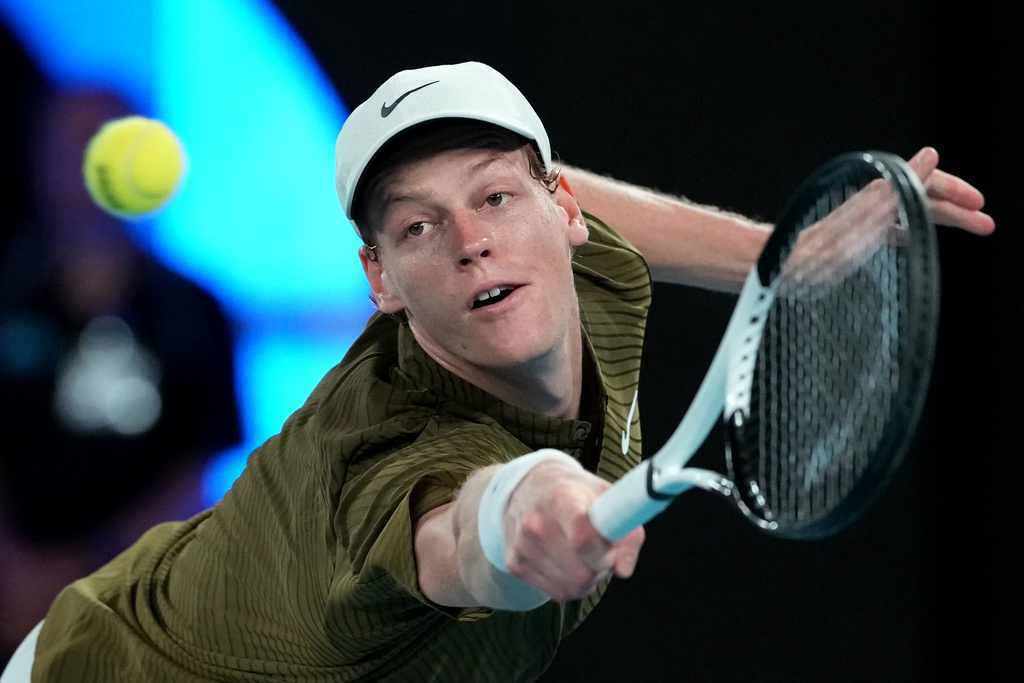 Jannik Sinner of Italy plays a backhand return to Ben Shelton of the U.S. during their quarterfinal match at the Australian Open tennis championship in Melbourne, Australia, Wednesday, Jan. 28, 2026. (AP Photo/Aaron Favila)