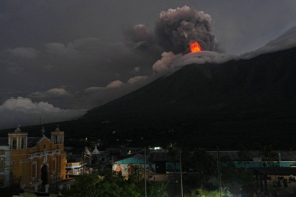 Lava flows and clouds of ash out of the crater of the Fuego Volcano, as seen from San Juan Alotenango, Guatemala, Tuesday, Aug. 4, 2026. (AP Photo/Moises Castillo)