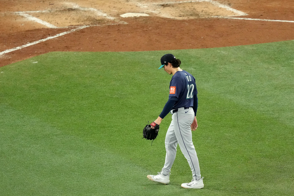 Seattle Mariners pitcher Bryan Woo walks back to the dugout after being pulled from the game during the seventh inning in Game 7 of baseball's American League Championship Series against the Toronto Blue Jays in Toronto, Monday, Oct. 20, 2025. (Chris Young/The Canadian Press via AP)