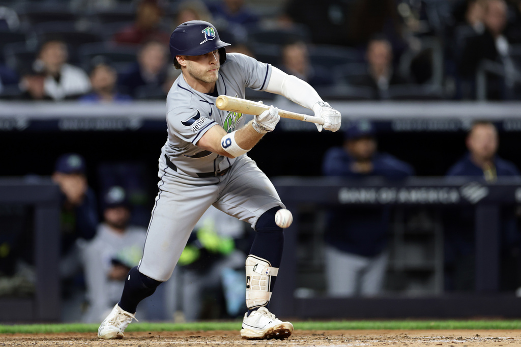 Tampa Bay Rays' Taylor Walls bunts a run scoring single in the seventh inning during the second baseball game of a doubleheader against the New York Yankees, Tuesday, Sept. 22, 2026, in New York. (AP Photo/Adam Hunger)