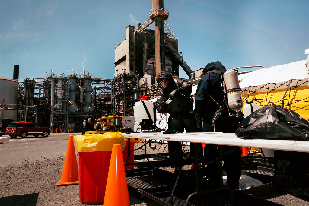 Soldiers and airmen from the Washington National Guard's 10th Homeland Response Force offer support to first responders following an implosion of a chemical tank at Nippon Dynawave pulp and paper mill on Thursday, May 28, 2026, in Longview, Wash. (Adeline Witherspoon/Washington National Guard via AP)