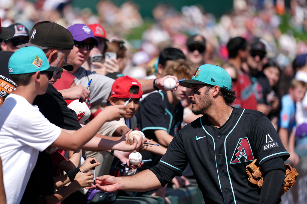 Arizona Diamondbacks' Nolan Arenado signs autographs prior to a spring training baseball game against the Los Angeles Angels Saturday, Feb. 28, 2026, in Tempe, Ariz. (AP Photo/Ross D. Franklin)