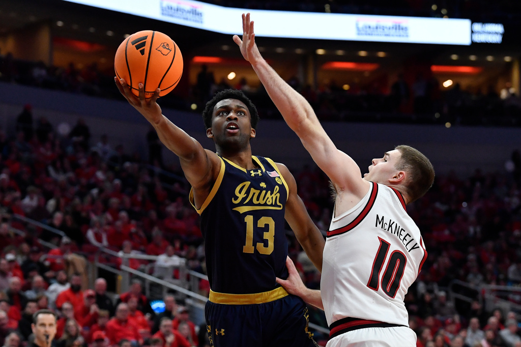 Notre Dame guard Sir Mohammed (13) shoots over Louisville guard Isaac McKneely (10) during the first half of an NCAA college basketball game in Louisville, Ky., Wednesday, Feb. 4, 2026. (AP Photo/Timothy D. Easley)
